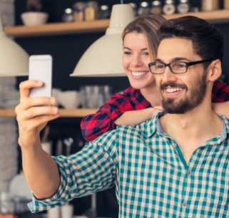 Man and woman taking selfie together