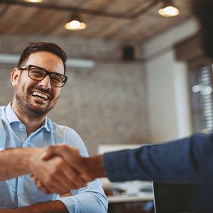 Heber City patient smiling while shaking hands with client at work 