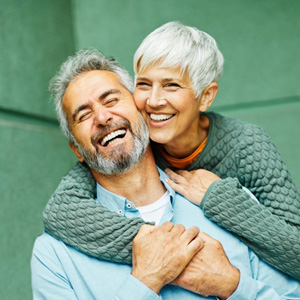Couple embracing on green background