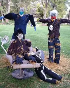 Several scarecrows covered in hay