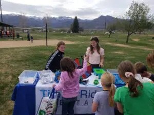 Group of kids at outdoor table that says TimberRidge Dental