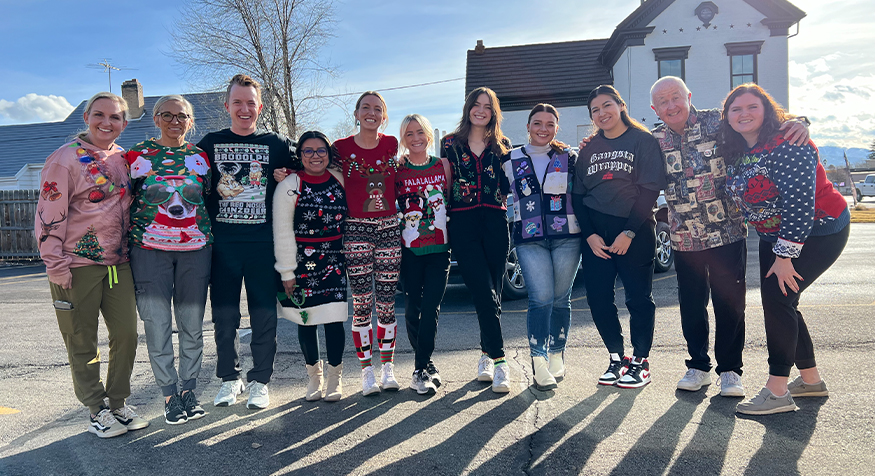 TimberRidge Dental team members smiling outdoors in holiday attire