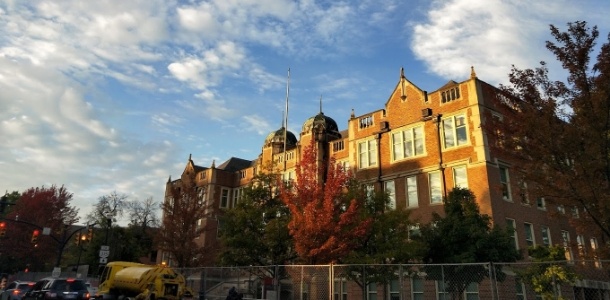 Exterior of brick university building at sunset