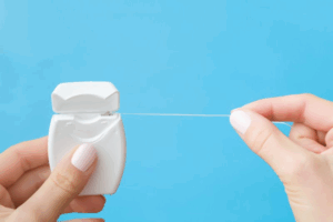 Hand pulling on dental floss